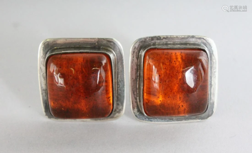 A LARGE PAIR OF SILVER AND AMBER EAR CLIPS.