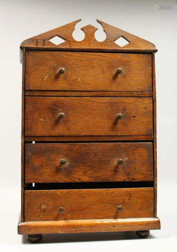 AN APPRENTICES OAK FOUR DRAWER TALLBOY, with arched