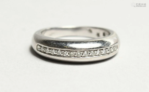 AN 18CT WHITE GOLD HALF ETERNITY RING.