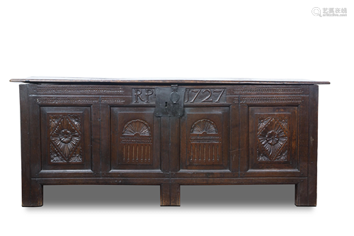 A Georgian carved chest dated 1727, executed in oak,