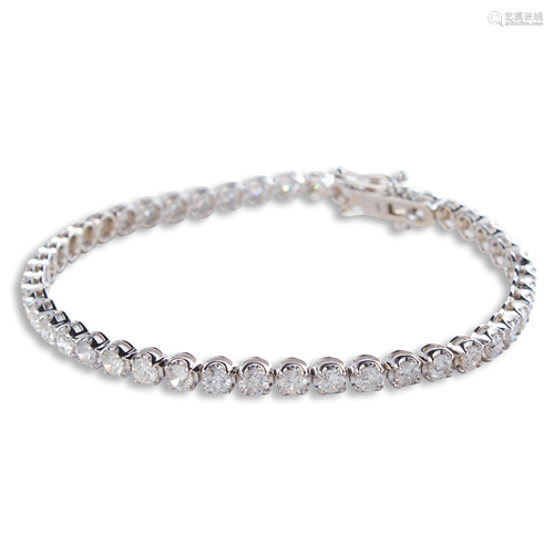 A diamond and fourteen karat white gold bracelet