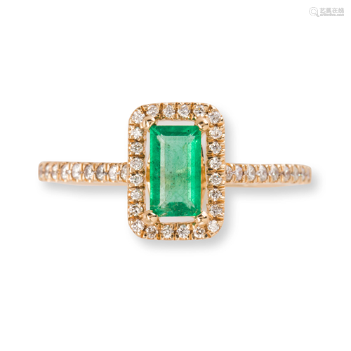 An emerald, diamond and fourteen karat gold ring