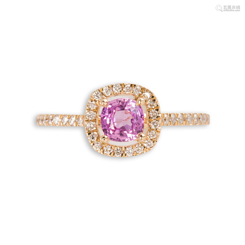 A pink sapphire, diamond and fourteen karat gold ring