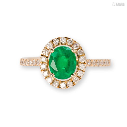 An emerald, diamond and fourteen karat gold ring