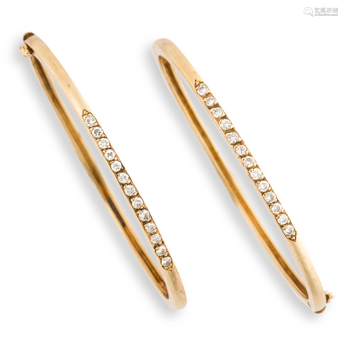 A pair of diamond and fourteen karat gold bangle