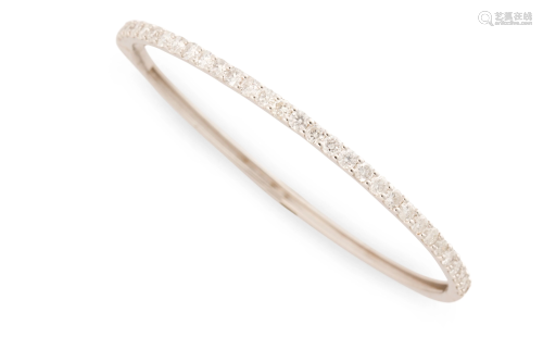 A diamond and fourteen karat white gold bangle bracelet