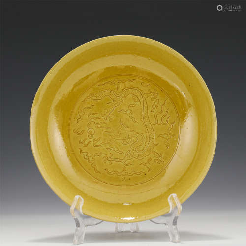A CHINESE YELLOW GLAZED INCISED PLATE WITH DRAGON PATTERN/MI...