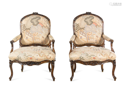 A Pair of Louis XV Style Carved Walnut Fauteuils