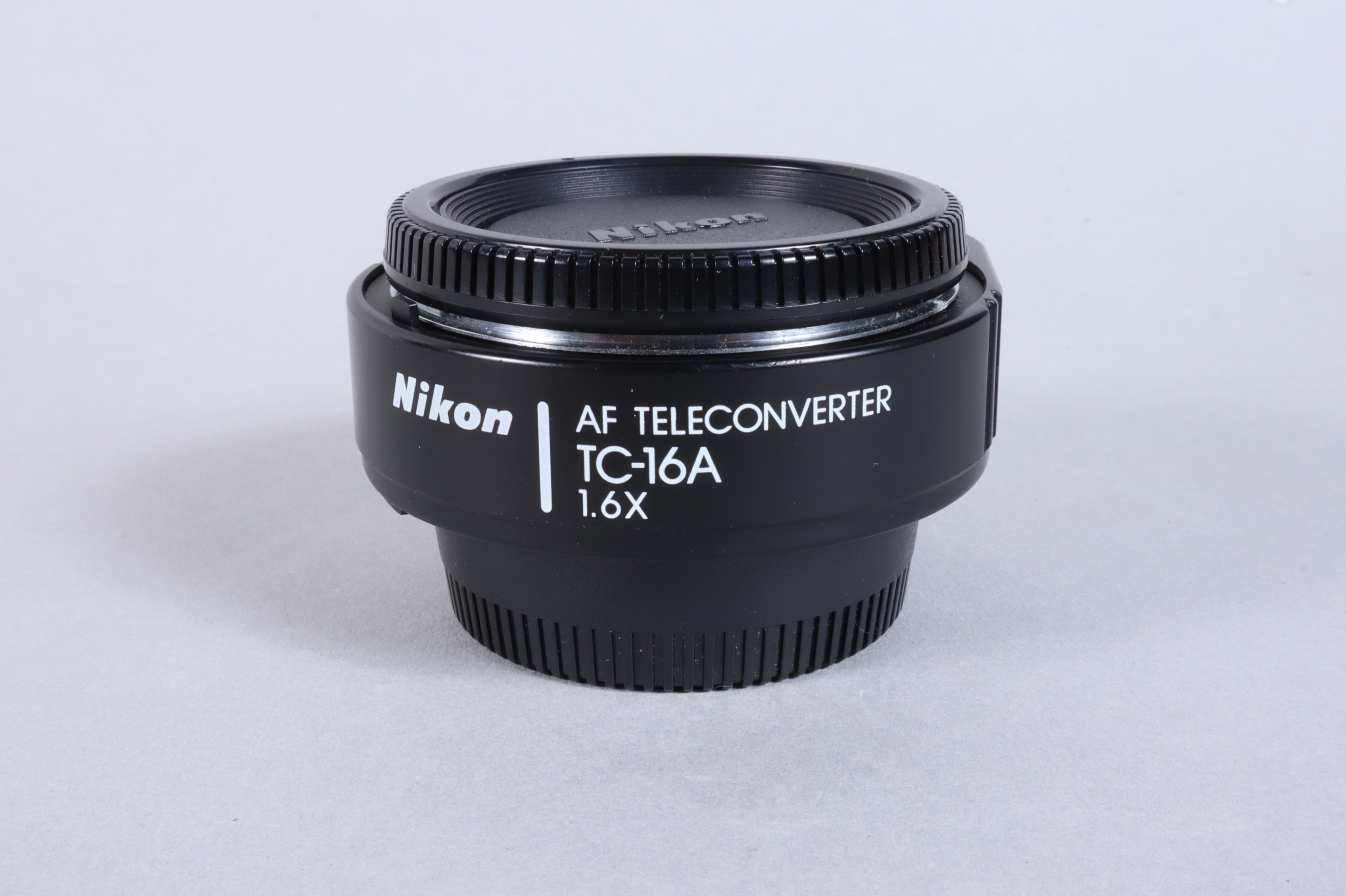 A Nikon TC 16A 1.6x AF Teleconverter, serial no 231957, body