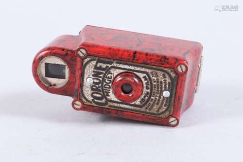 A Coronet Midget Miniature Camera, red, shutter working, bod...