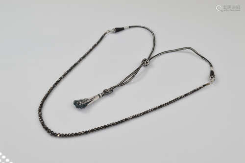 A certificated black diamond single strand necklace, of grad...
