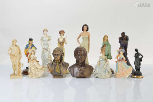 A collection of thirteen resin figures, including Mozart bus...