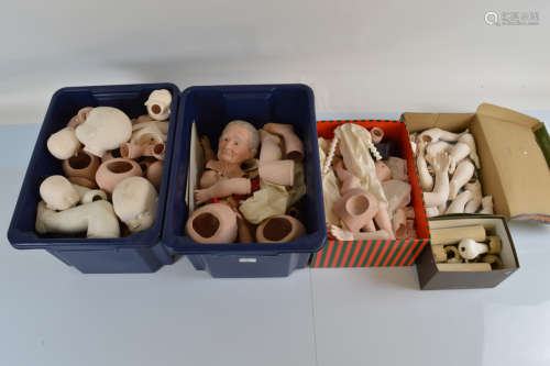 A large quantity of assorted porcelain doll heads and limbs,...