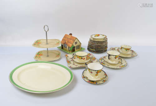 A Royal Doulton part Art Deco teaset, with heightened floral...