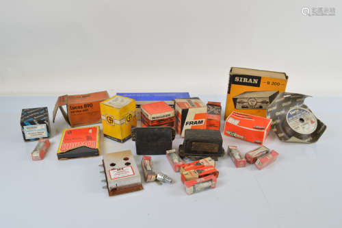 A collection of car and engine parts, including spark plugs,...