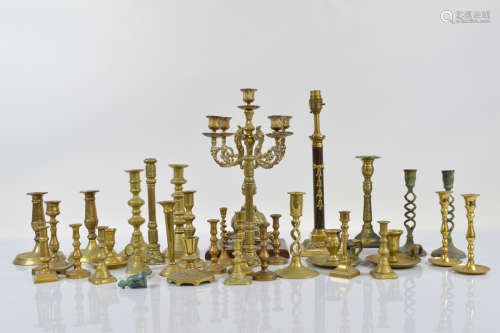 A brass ornate four branch candelabra, on a hardwood base to...
