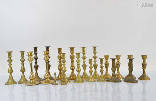Eleven pairs of brass candlesticks, various styles