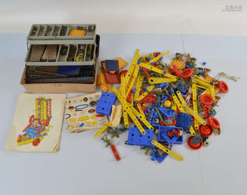 A mixed lot of unboxed Meccano parts, plastic and metal exam...