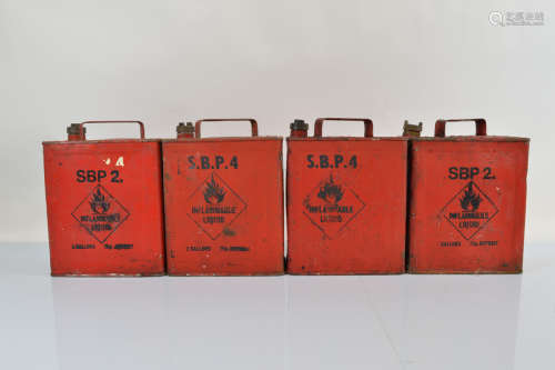 Four red painted petrol cannisters, impressed SM and BP Ltd