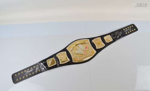 A WWE Commemorative signed spinner Champ belt, the black lea...
