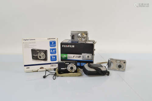Three digital cameras, including a Fujifilm fine pix F31FD, ...