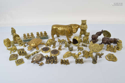 A collection of brass animal figures, including a heavy cast...
