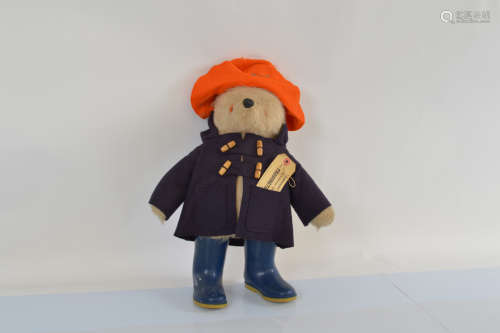 A Gabrielle Paddington Bear, with orange hat, dark blue coat...