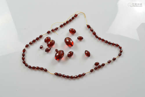 A string of translucent faceted 'cherry amber' beads, larges...