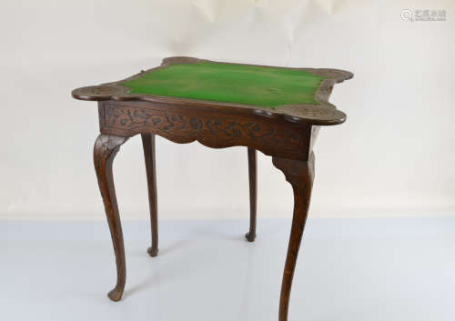 An early 20th Century Queen Anne style carved oak card table...