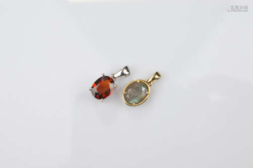 Two certificated 9ct gold gem set pendants, comprising an ov...