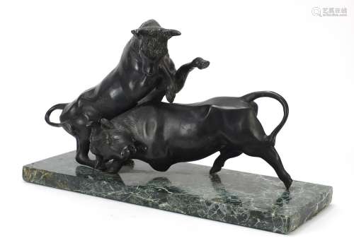 Patinated bronze study of two stylised fighting bulls raised...