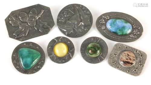 Seven Arts & Crafts brooches including one with sterling sil...