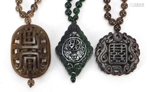 Three Chinese carved hardstone pendant bead necklaces, the l...