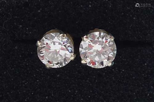 Pair of 14ct gold diamond solitaire earrings, each approxima...