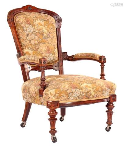 Walnut armchair with floral upholstery and decorated