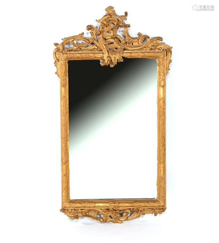 Faceted mirror in richly decorated gold-colored frame