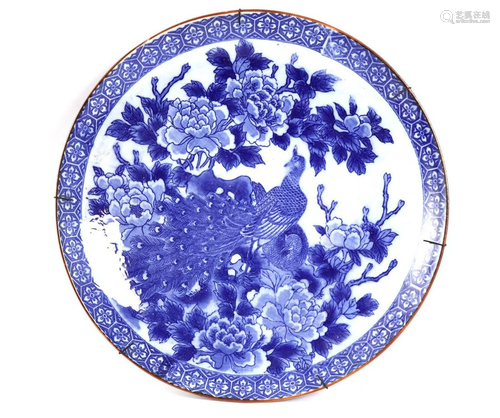 Porcelain wall plate with blue and white peacock