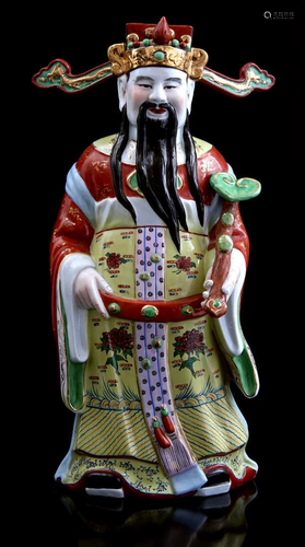 Porcelain statue of a standing Oriental man with a