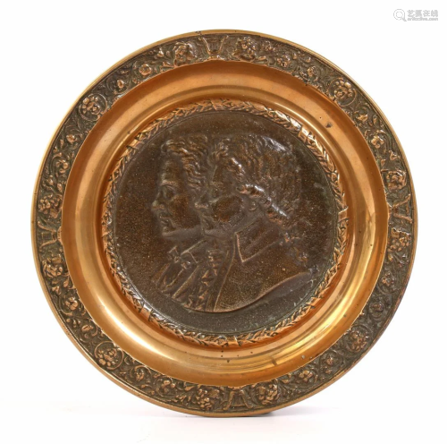 Bronze richly decorated dish with double portrait in