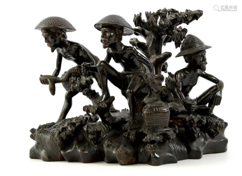 Wooden bombarded sculpture group of workers, Indonesia