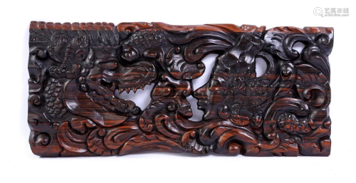 Carved ebony wall relief depicting a dragon with person