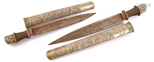 2 metal Asian daggers in richly decorated metal sheaths