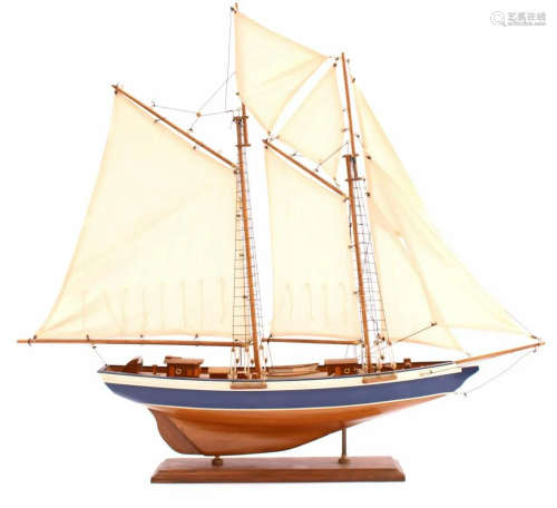 Wooden scale model sailing boat on stand