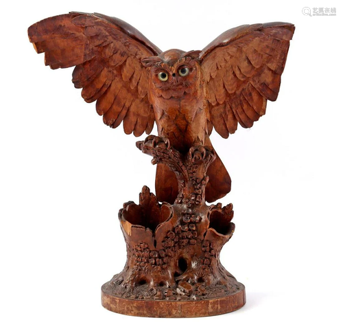 Wooden bombarded statue of an owl