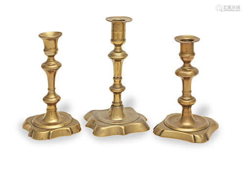 Three George II brass alloy socket candlesticks, circa 1730-...