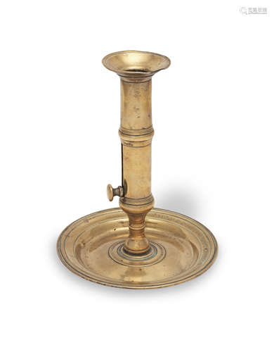 An unusual George II brass ejector candlestick, circa 1740 E...