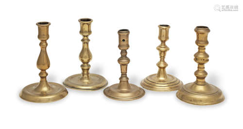 Five brass alloy round-based socket candlesticks