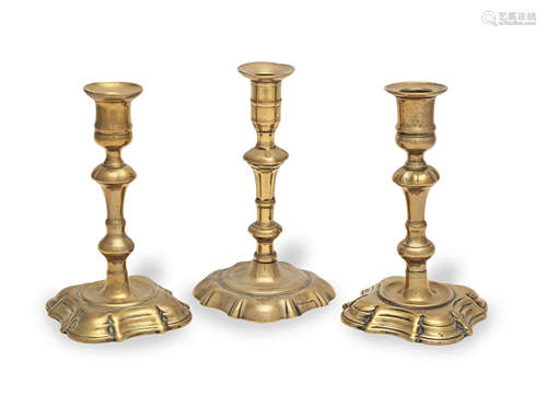 Three George II brass alloy socket candlesticks, circa 1730-...