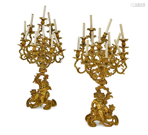 A PAIR OF NAPOLEON III GILT BRONZE TWELVE-LIGHT FIGURAL CAND...