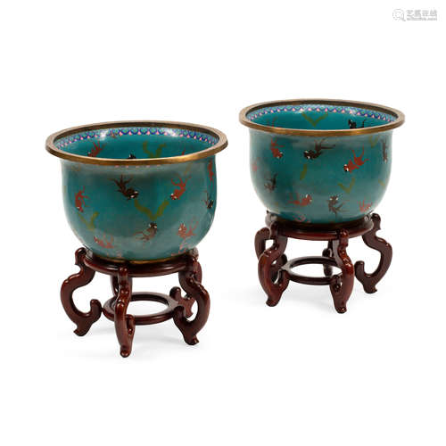 A PAIR OF CHINESE CHAMPLEVÉ ENAMEL FISH BOWLS ON CARVED WOOD...